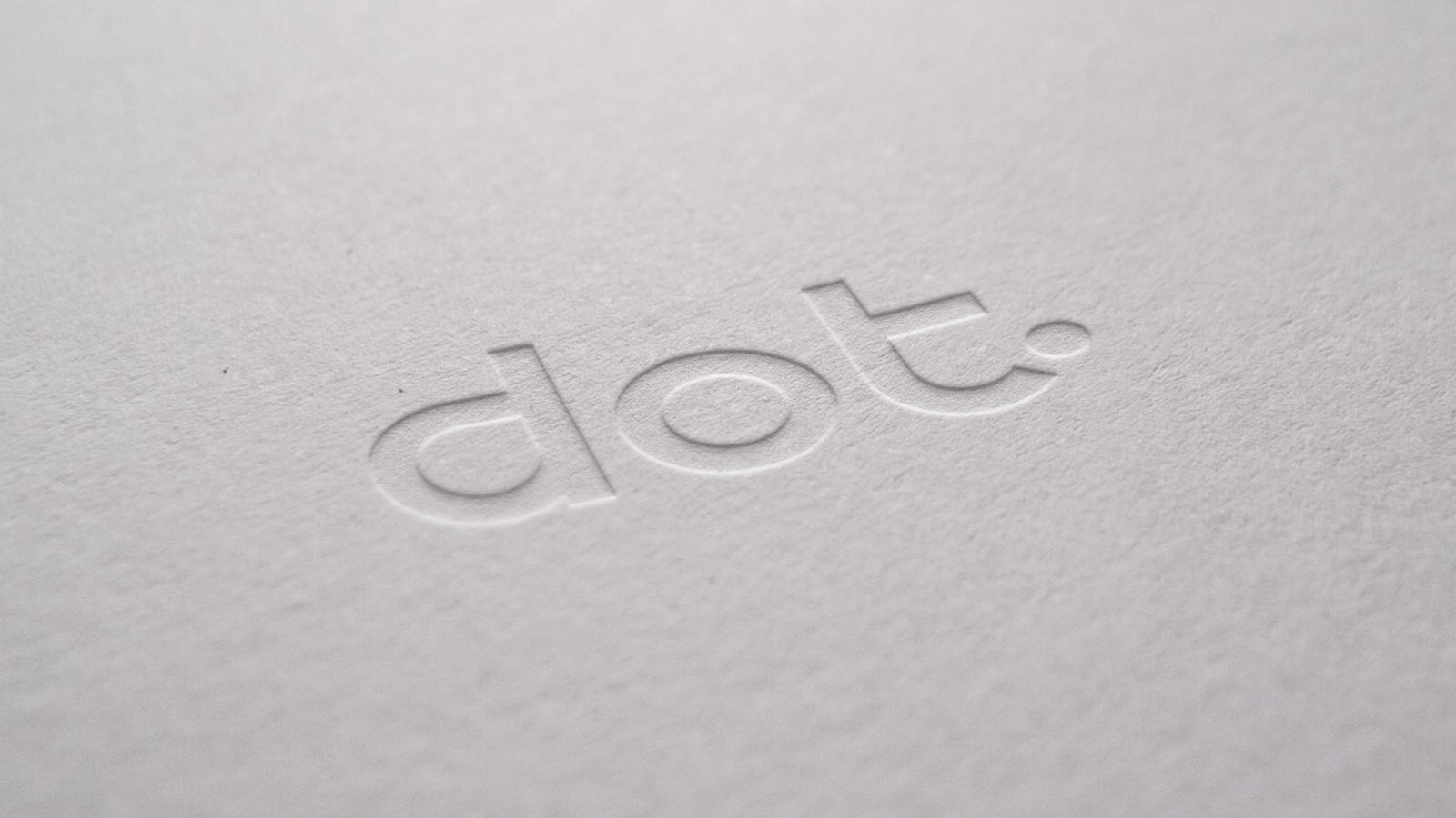 A mock of Digital Opportunity Trust logo embossed on white paper